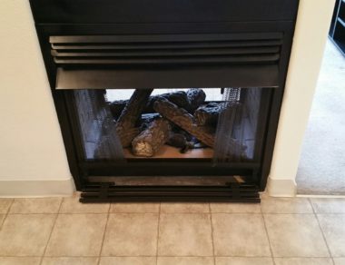 A black gas fireplace in a home to illustrate gas fireplace safety tips